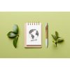 Eco-friendly,Empty,Notebook,With,Pen,And,Green,Leaf,On,Colored