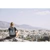 Young,Tourist,Woman,Sitting,On,Top,Of,Mountain,And,Looking